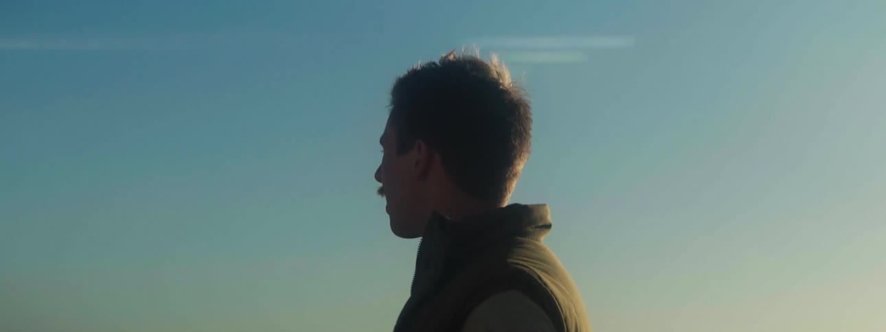 A man stands outside and looks around