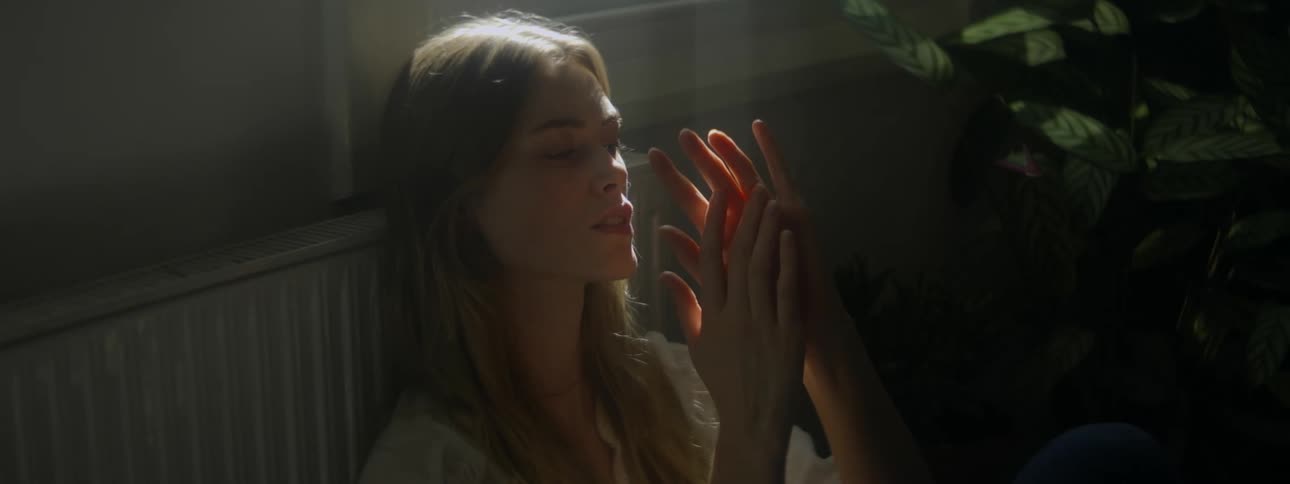 A woman is resting against the wall