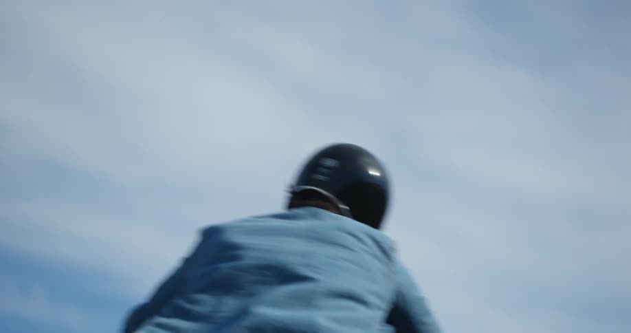 A man is turning the corner on the road with his motorcycle