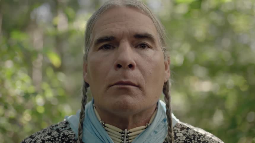 A native man standing outside