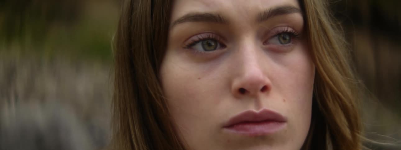 Close up of the face of a beautiful young woman looking at the horizon