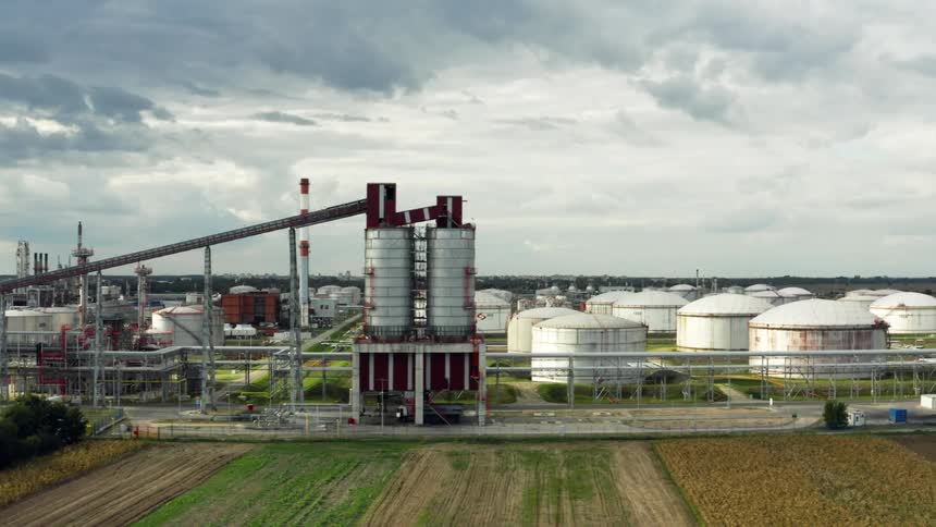 A large factory complex under a cloudy daytime sky in the Balkans