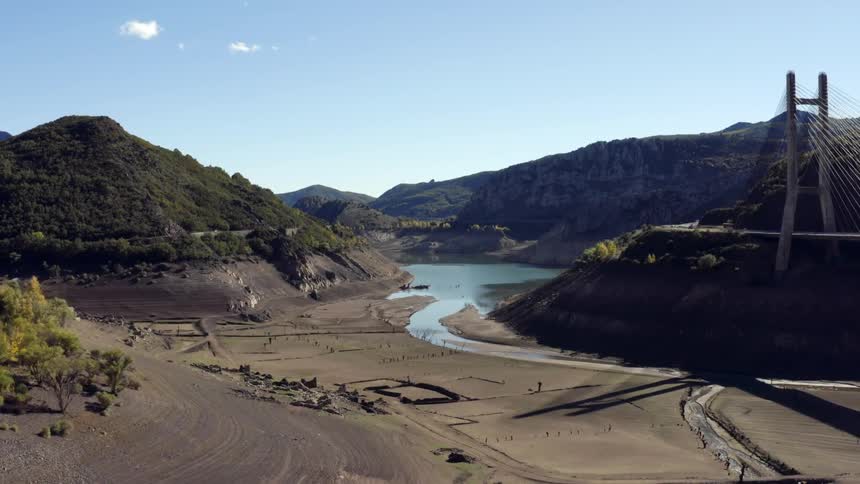 Birds fly over the dry river bed in Spain