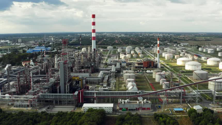 A large refinery under a cloudy daytime sky in Eastern Europe