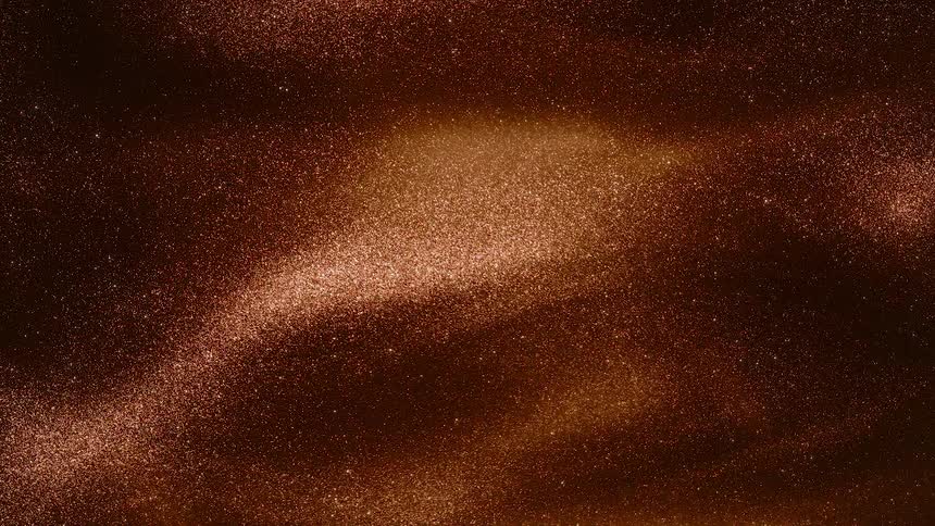 Orange glitter bubbles up and reflects light on the peaks
