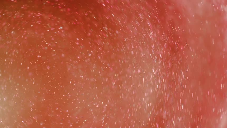 Twinkling glitter is floating in a spinning red and orange organic glowing environment