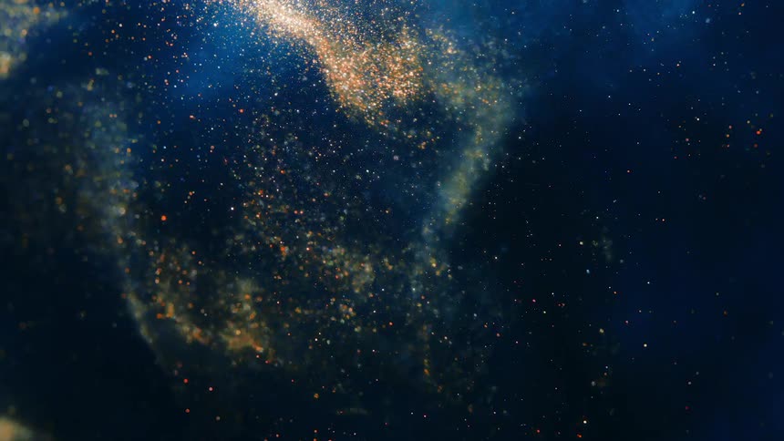 Shimmering gold light and glitter flowing and splashing against deep blue