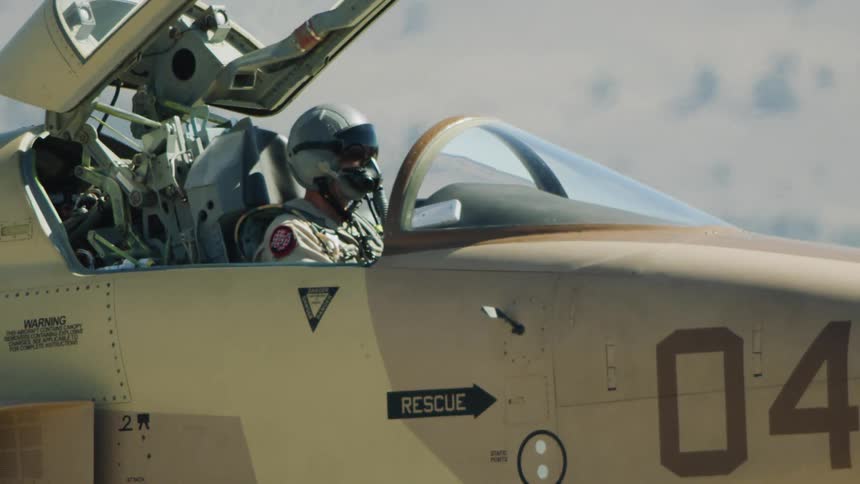 A fighter pilot performs pre-flight checks in their F-15 fighter jet before take off