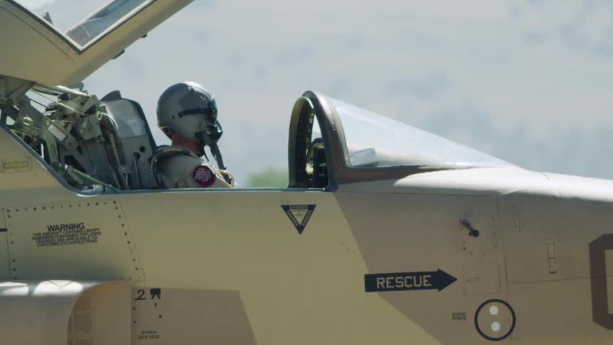 A fighter pilot prepares pre flight checks in their F-15 fighter jet