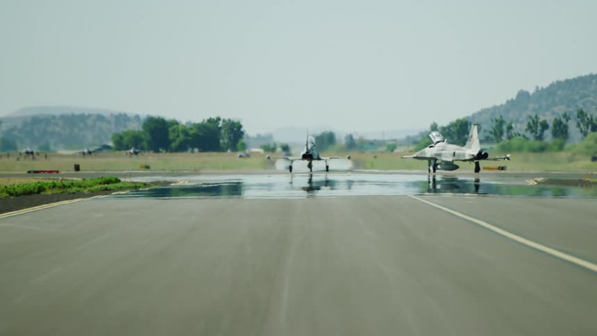 F-15 fighter jets taxi towards take off on an airfield before a patrol flight