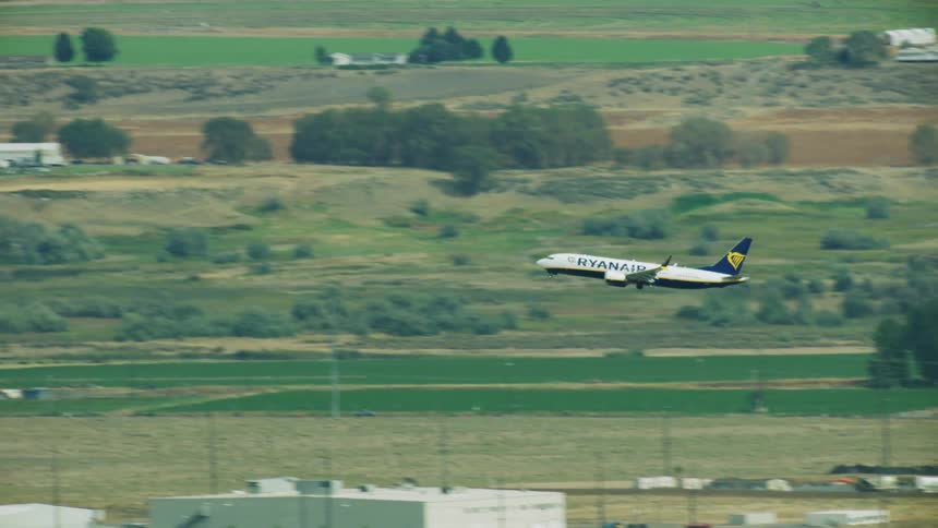 A passenger plane takes off from an airfield