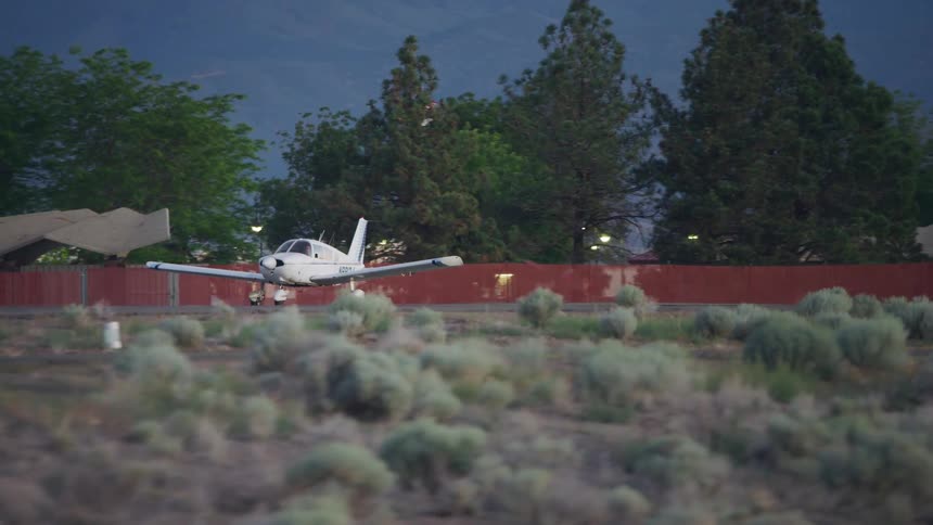 A small private Piper PA-28 Cherokee taxis towards the runway in preparation for take off