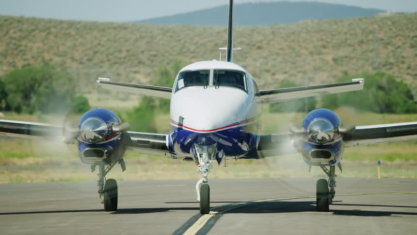 A Beechcraft King Air performs an engine run up prior to take off from a small rural field