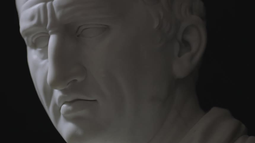 A white statue in a dark room