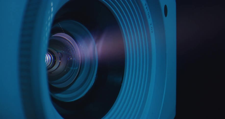 Smoke swirls inside the indent of a camera lens