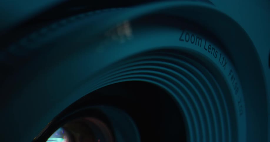 Light shines through zoom lens with textured concentric circles surrounding glass