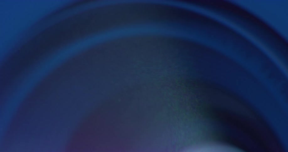 Close up of dust particles moving in the air in front of the lens of a projector
