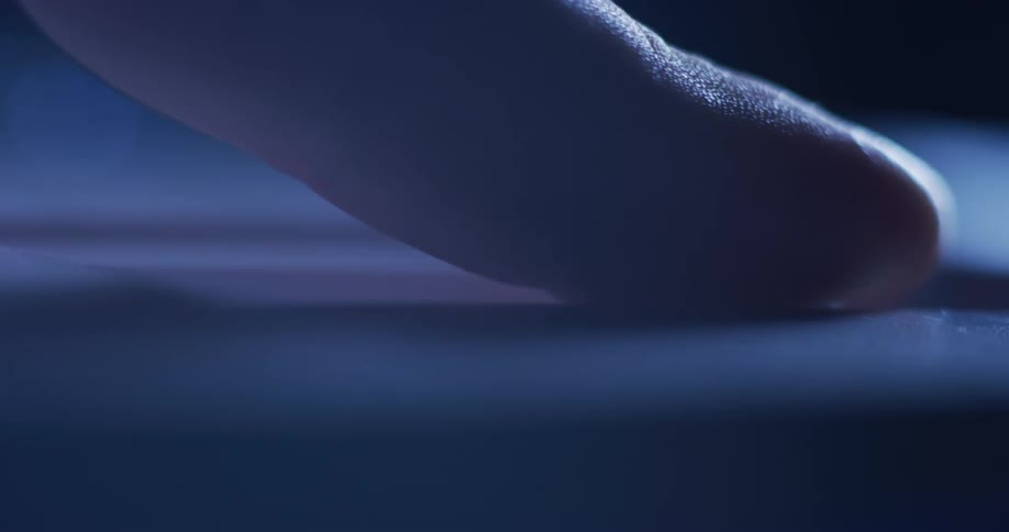 A person places their finger near a switch and pushes it forward