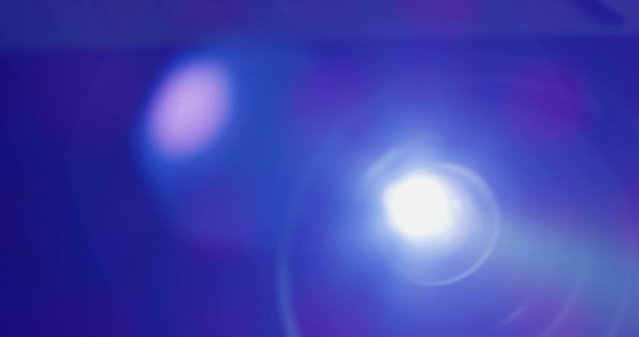 Light shines brightly glaring from machine emitting a blue light through vent