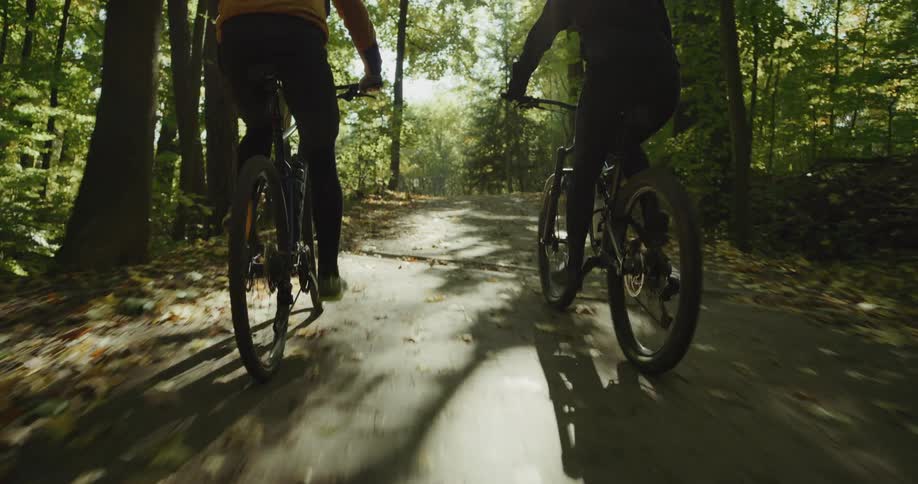 Two people riding bicycles outdoors