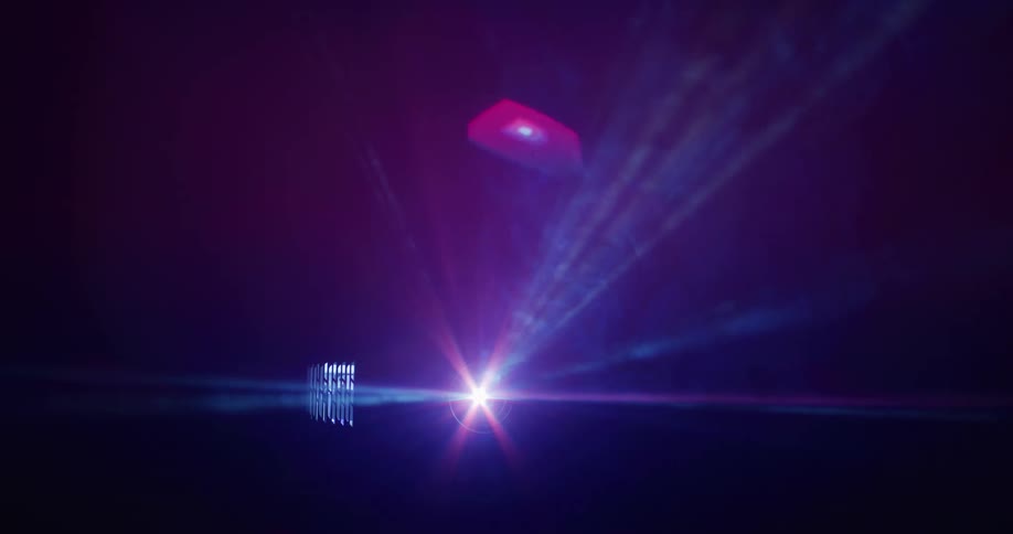 A projector projects color changing lights in a dark room