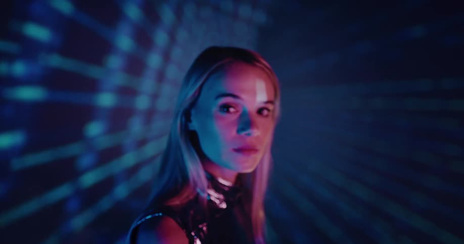 A woman is standing in a futuristic room