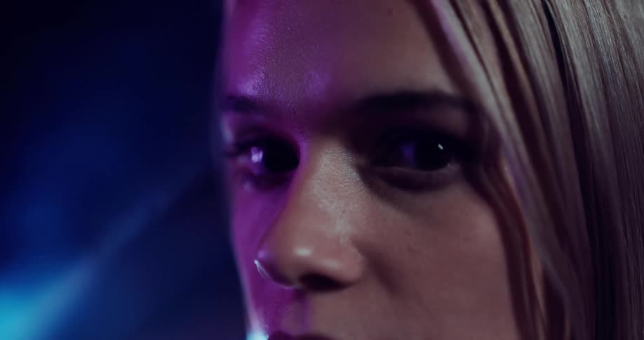 Close up view of a womans face is displayed at night