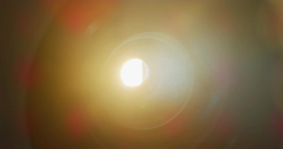 Spotlight shining from machine colors rising gas