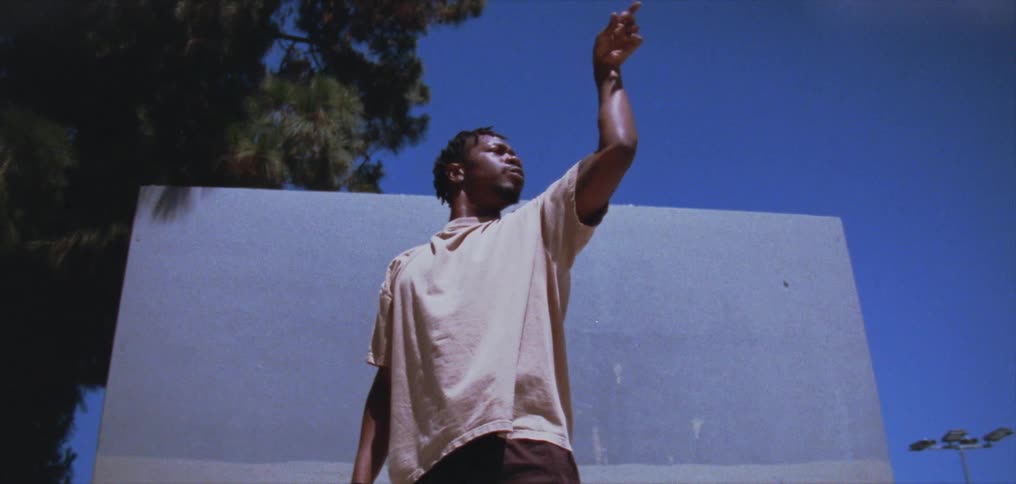 A man is standing outdoors during the spring time