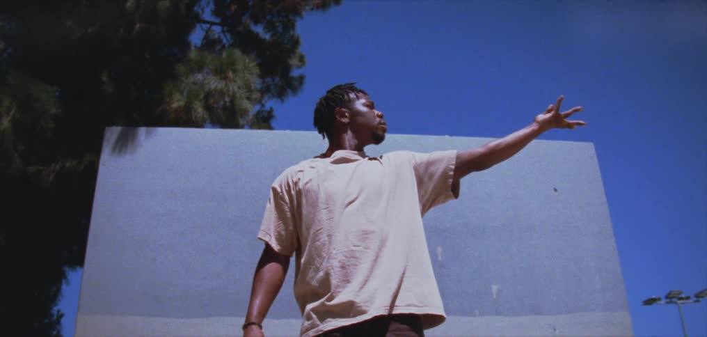 A man is stretching his arm outdoors during spring