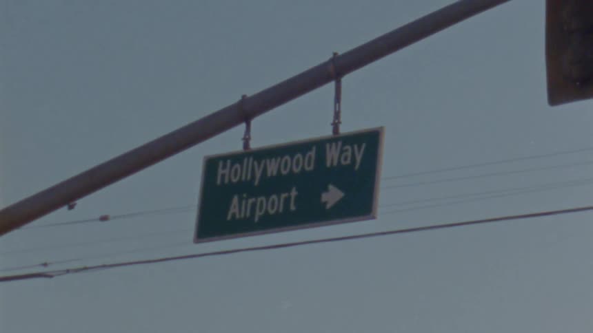 A street sign hangs from the pole