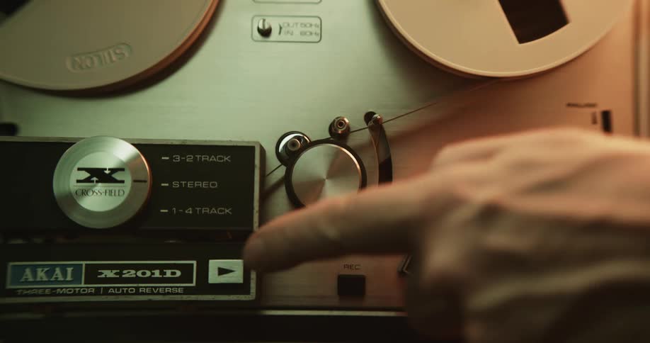 A man adjusts a setting on a movie projector