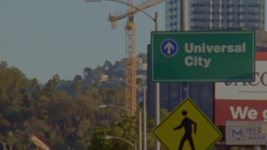 Traffic signs are in front of the building