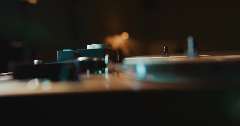 A person adjusting a disc on a record player