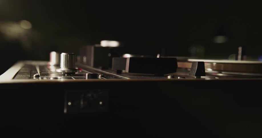 A man hits a button on a vintage style projector