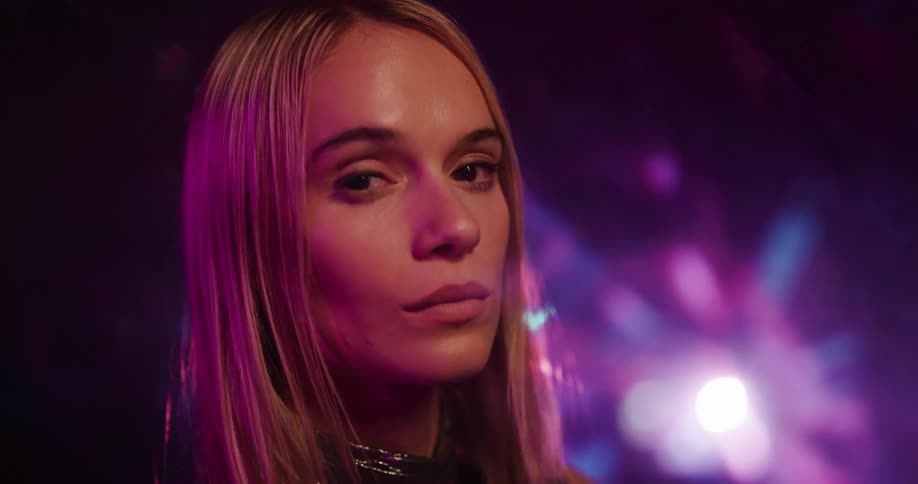 Bright lights shining behind a woman posing for a portrait