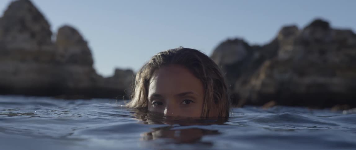 Woman's face as seen halfway submerged in water