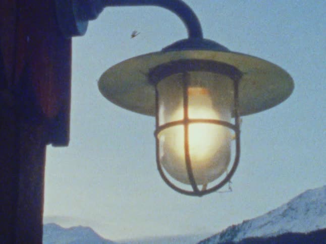 A light in front of a mountain range turns off