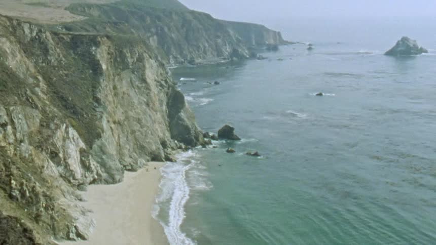 The view is of the ocean and the beach in the day time
