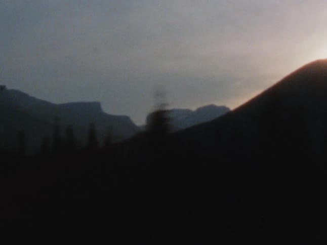 The sun is rising behind the mountain