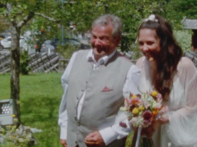 A father escorting his daughter bride during a wedding ceremony