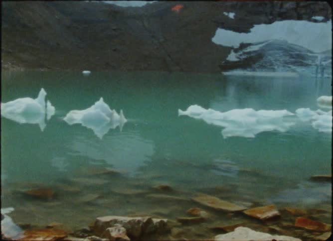 A woman meditating next to a lake with chunks of ice