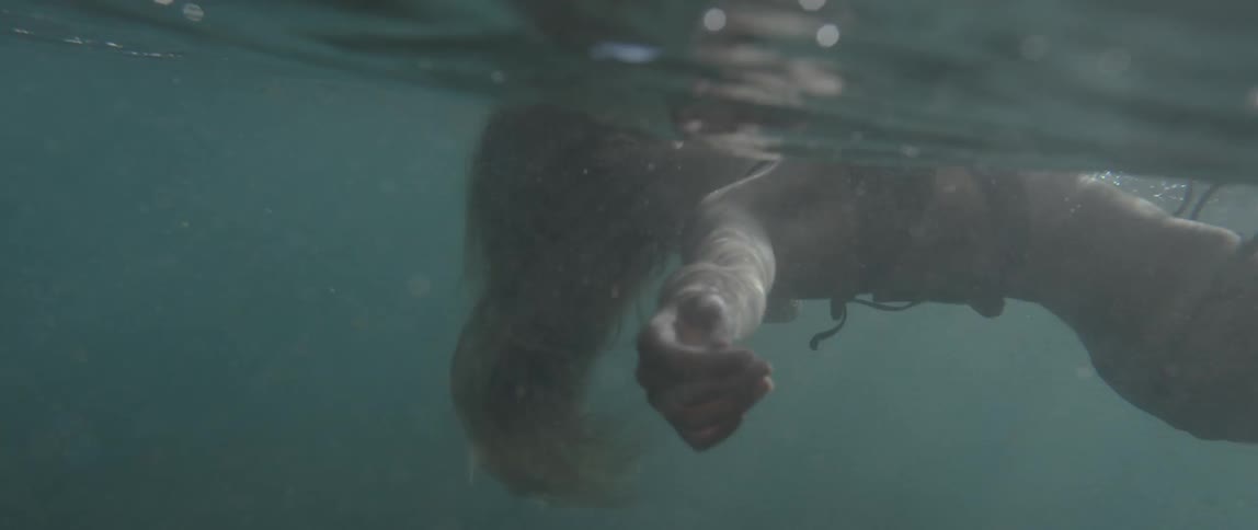 Woman floating on her back as seen from just under the waterline