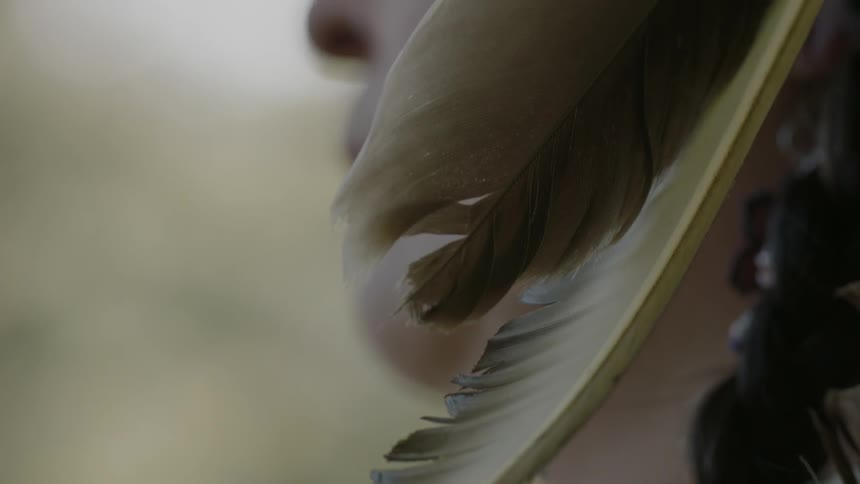 A native american woman with a feather ornament in her hair