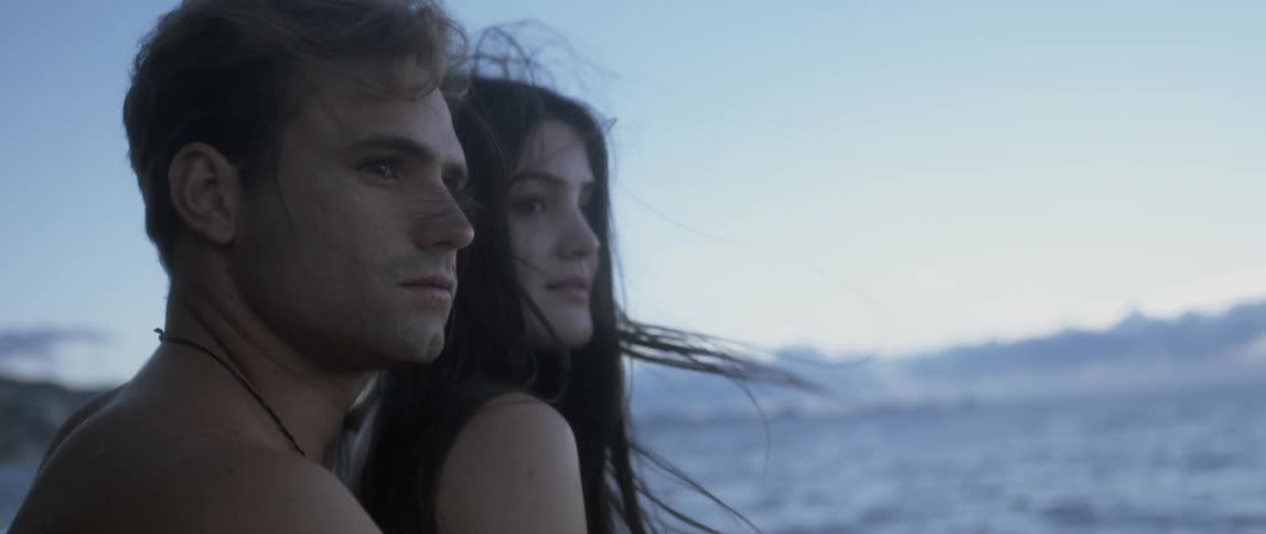 A man and a woman both look off in the distance