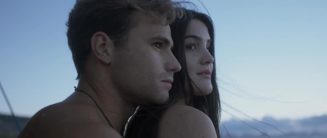 A man and woman standing outdoors and hugging