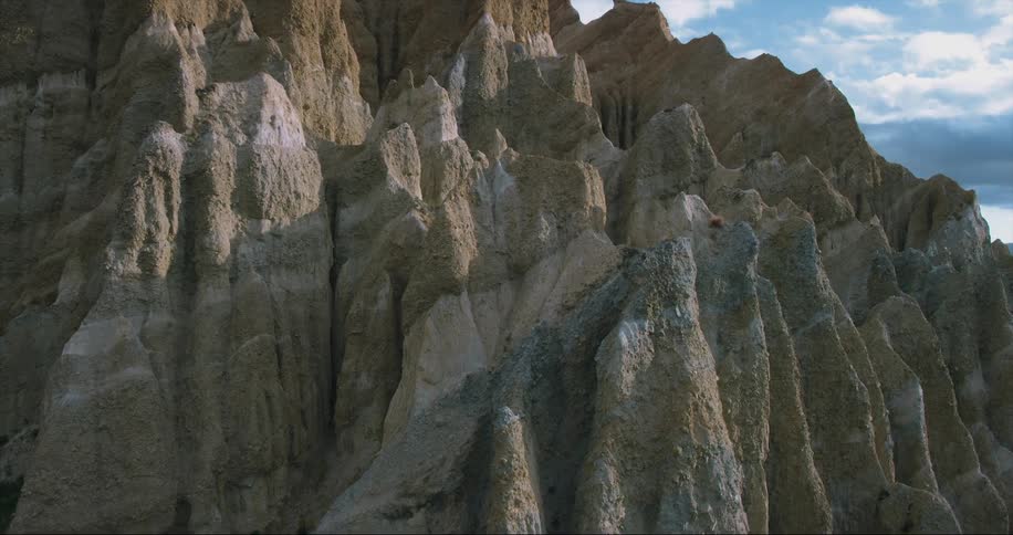 Sharp ledges stick out from the side of a mountain