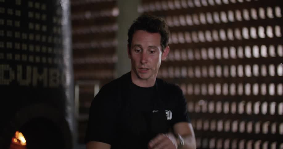 A male restaurant employee preparing food in the kitchen