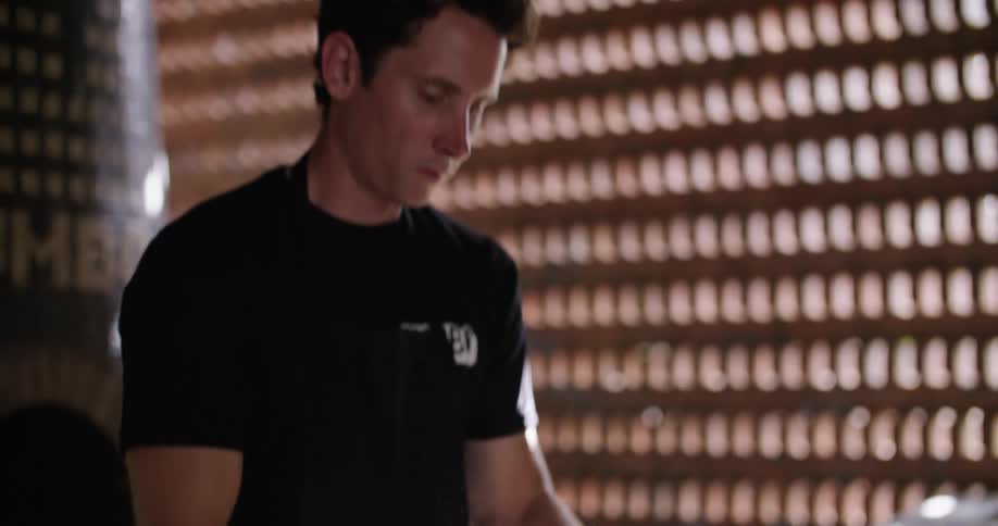 Man kneading pizza dough over the table in the restaurant kitchen