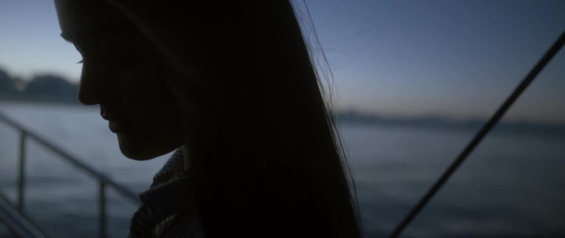 Close-up of a woman on a ship as the wind blows through her hair